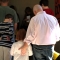 port--A father and daughter participate in a prayer during a prayer meeting at a local middle school.
